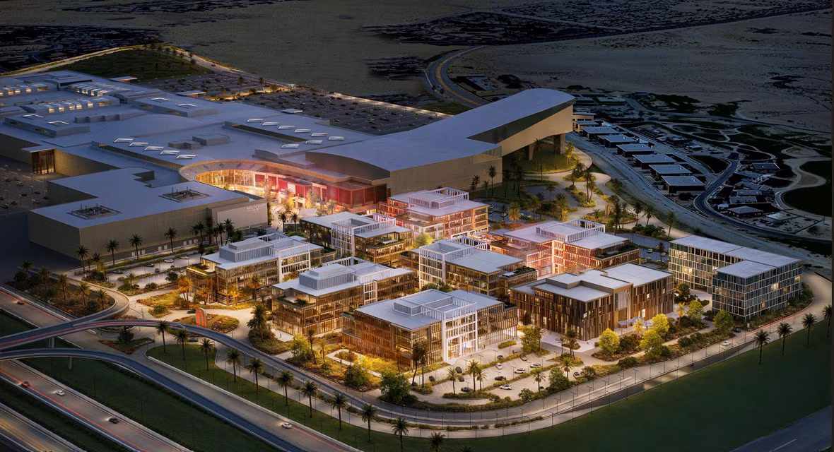 Night-time aerial rendering of JUNCTION office buildings and landscaped public spaces beside Mall of Egypt