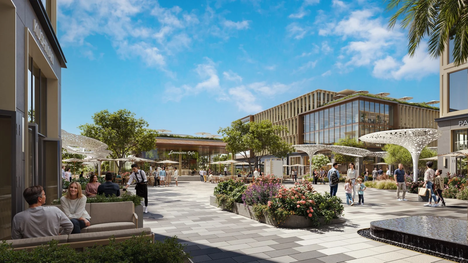 JUNCTION pedestrian plaza with café seating, flowering planting, shade canopies, and a water feature
