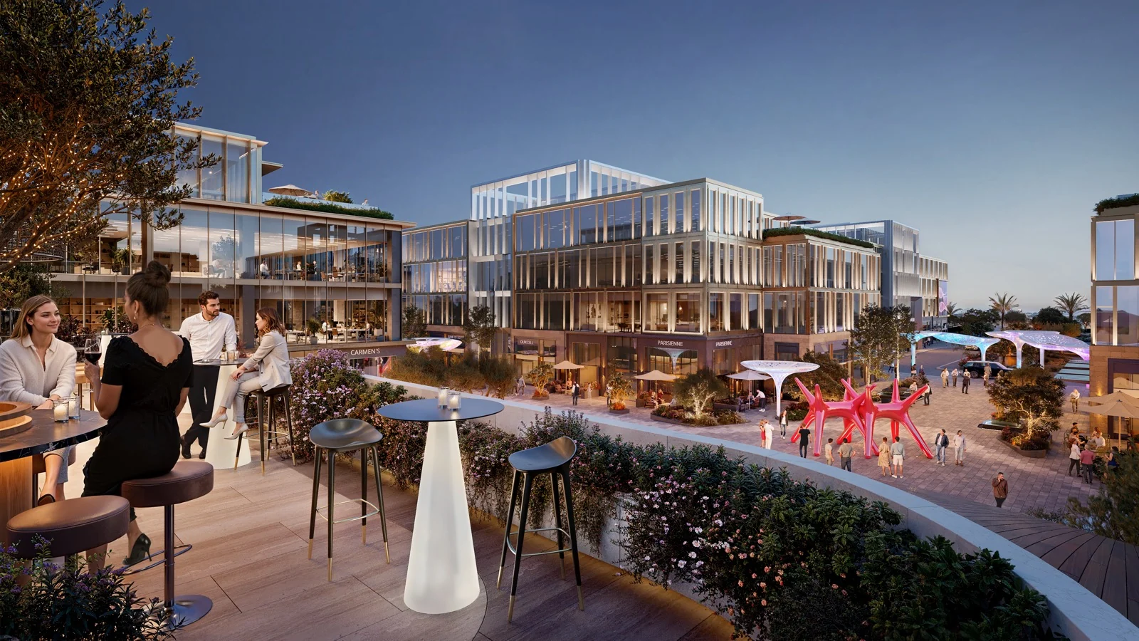 Evening view from a planted terrace overlooking JUNCTION’s central plaza, dining frontages, and illuminated shade canopies