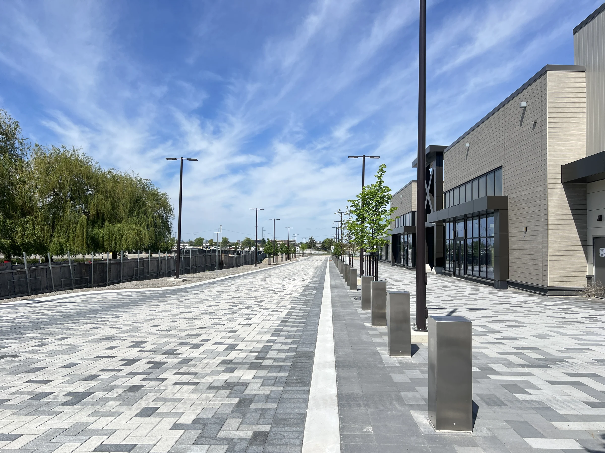 Completed Woodbine Block 9 streetscape with patterned paving, pedestrian space and retail frontages