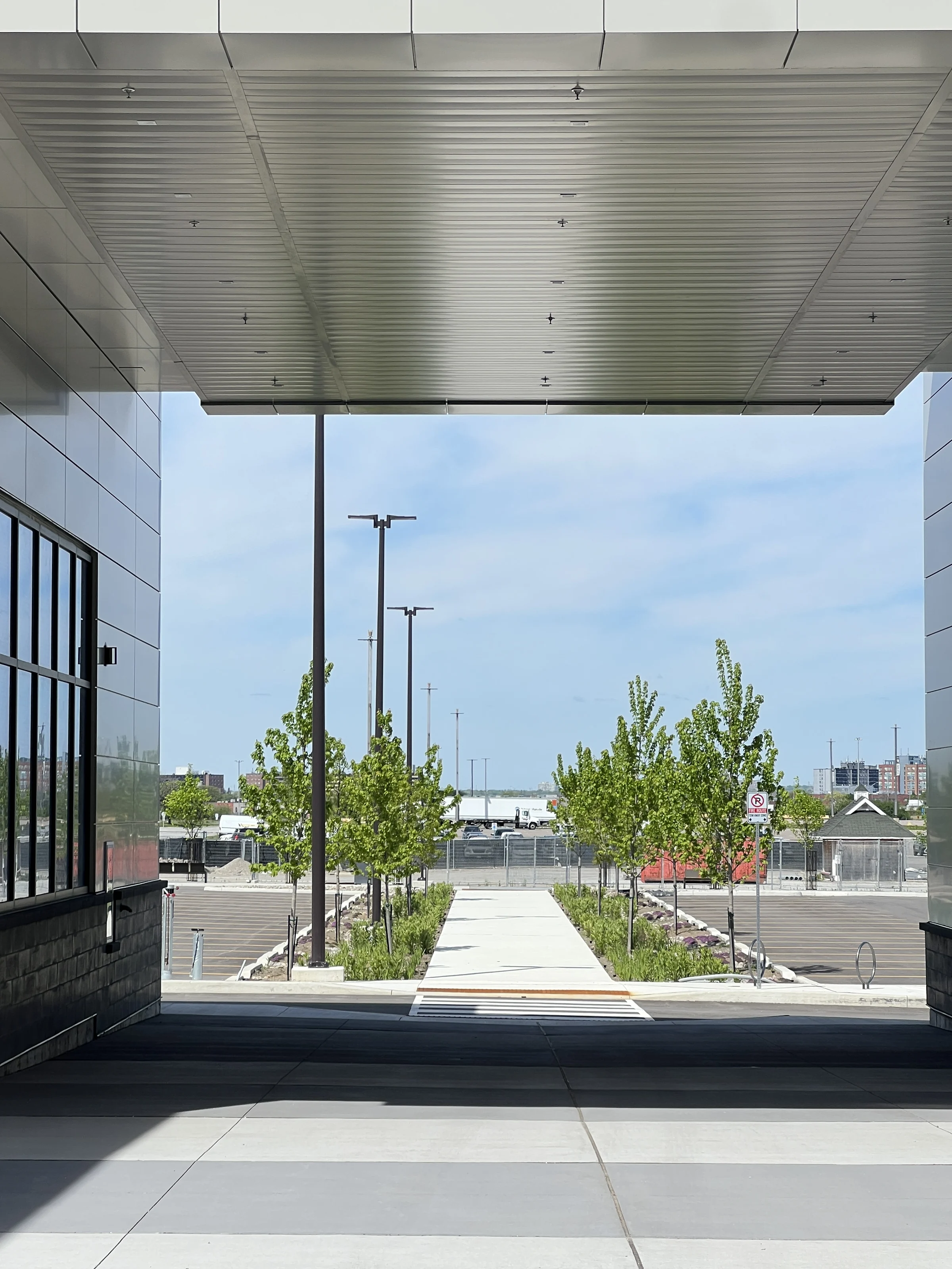 Woodbine Block 9 — Pedestrian route framed by the building canopy and planting.